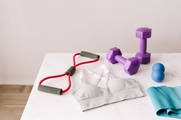 White padded sports bra flat lay with dumbbells