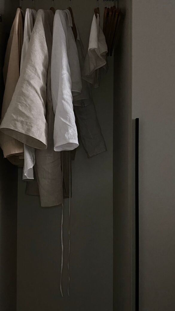 Linen clothes on hangers, breathable neutral fabric