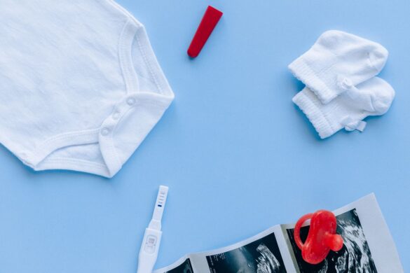 Flat lay of baby essentials and pregnancy test