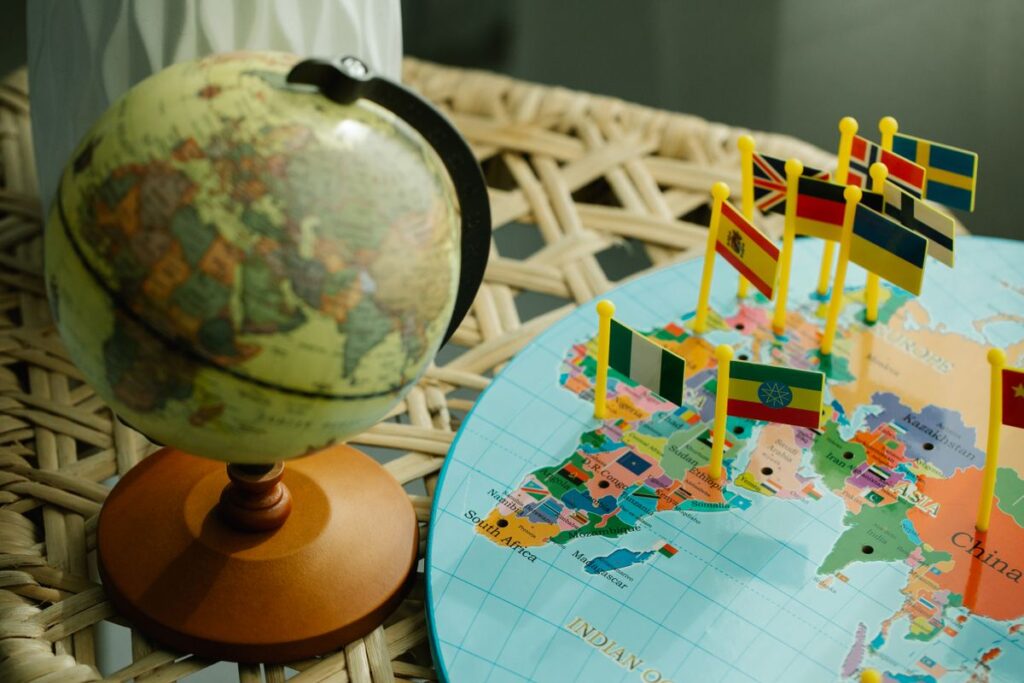 Globe and world map with country flags, representing international bra sizing