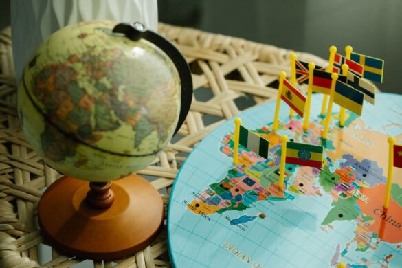 Globe and world map with country flags, representing international bra sizing